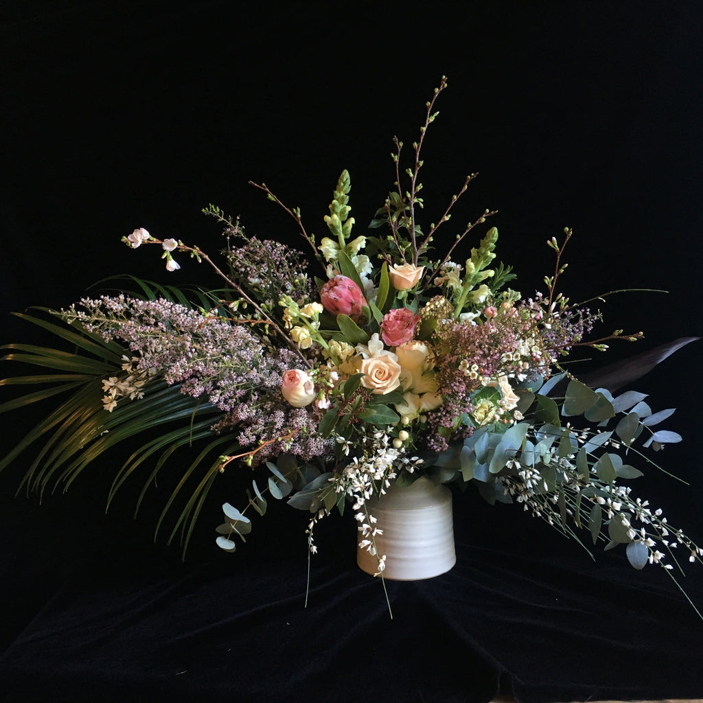 white and muted tones against a black velvet backdrop