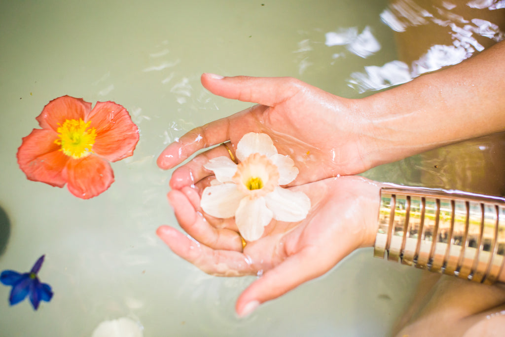 Flowers floating in the bathtub, part of a series from a Gorgeous and Green flower installation and photo shoot